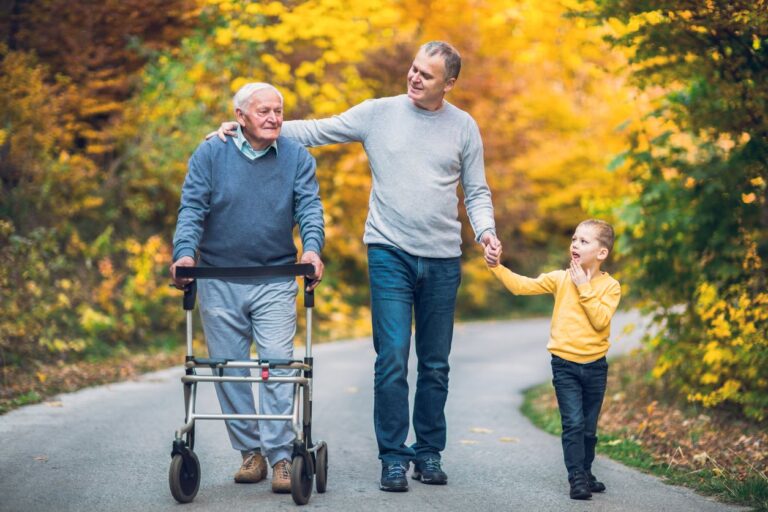 elderly man walking with family